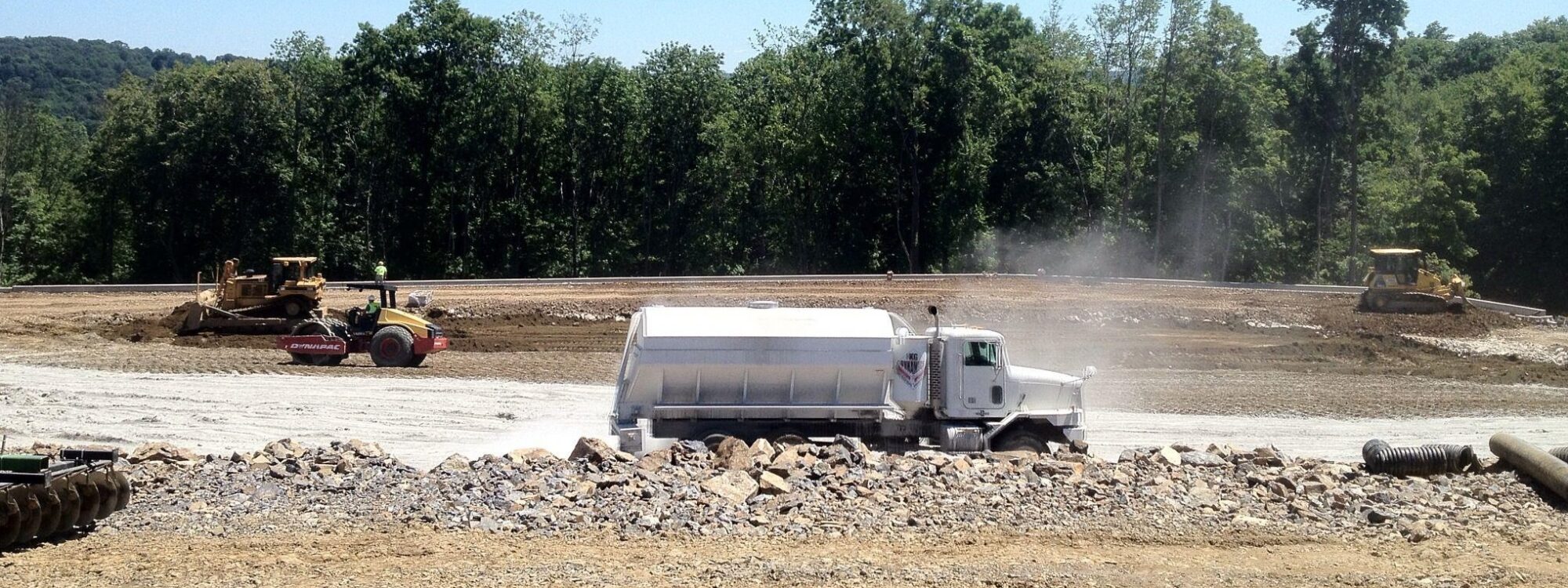 Sweeney, spreader truck, trees in background, aggregate in foreground, 2012-8-7-Spreader-1-1-1