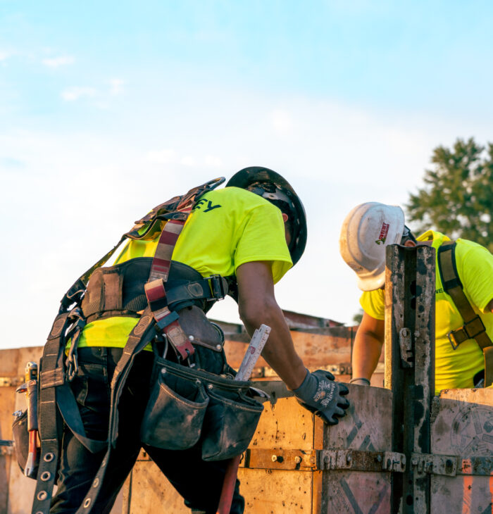 Sweeney employees working, harness, tool belt, hunched over, 24075_BUILDWITT_1037