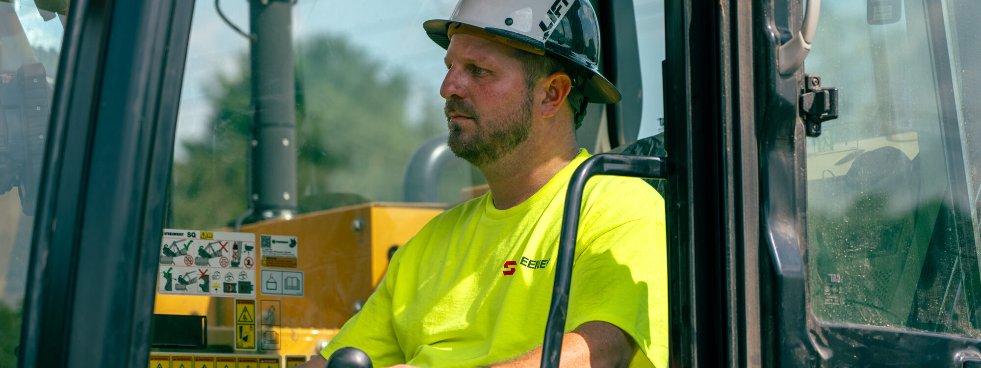Sweeney, employee in white/black hard hat, green visibility shirt, operating heavy equipment, 24075_BUILDWITT_1611.